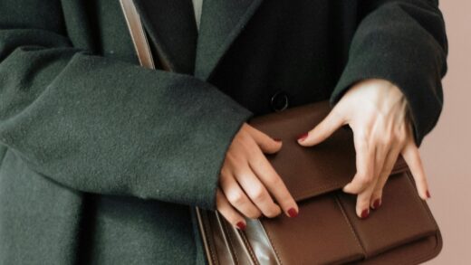 woman holding brown leather bag